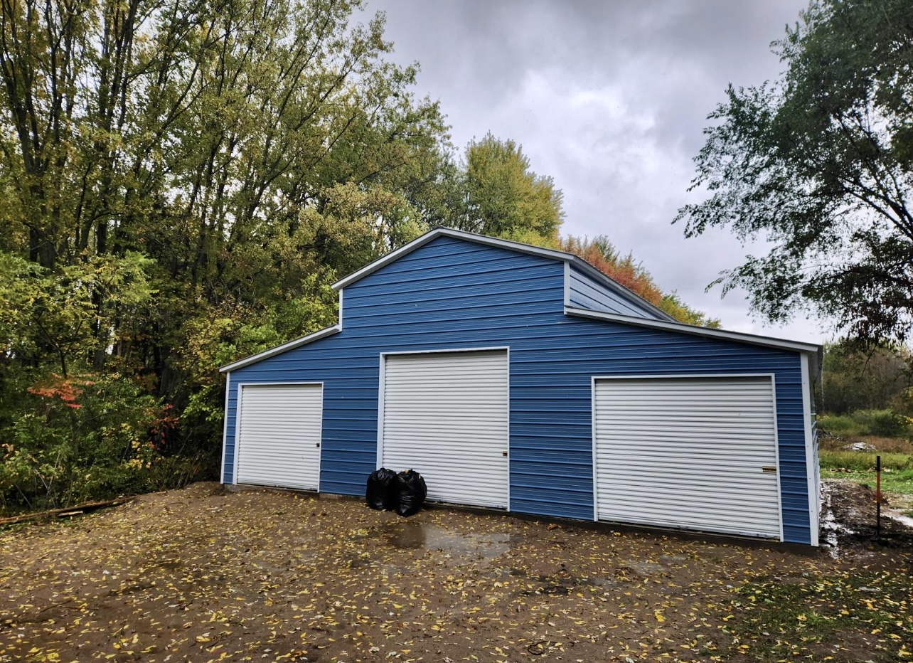 Red Steel Agricultural Barn with Tractor